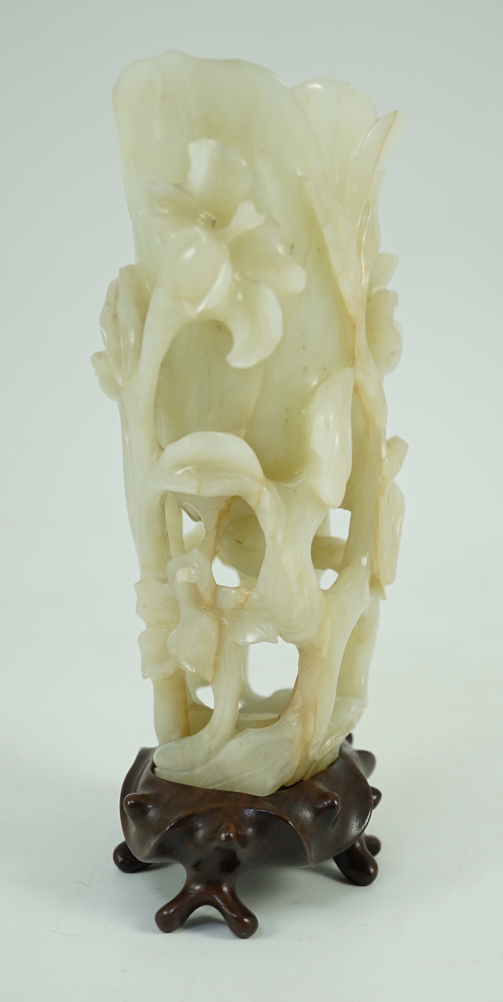 A large Chinese pale celadon jade ‘magnolia’ cup, 17th/18th century 17.5cm high excluding wood stand